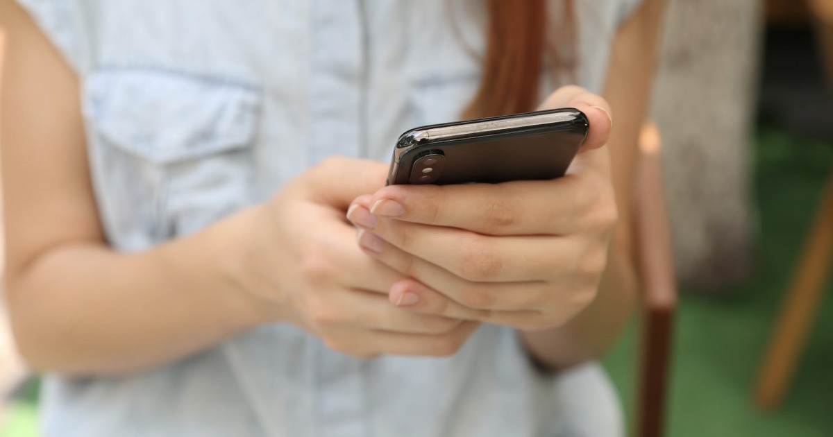 An iPhone on a desk representing personal privacy and unauthorized phone access.